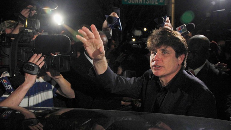 Former Illinois Gov. Rod Blagojevich waves as he departs his Chicago home for Littleton, Colo.