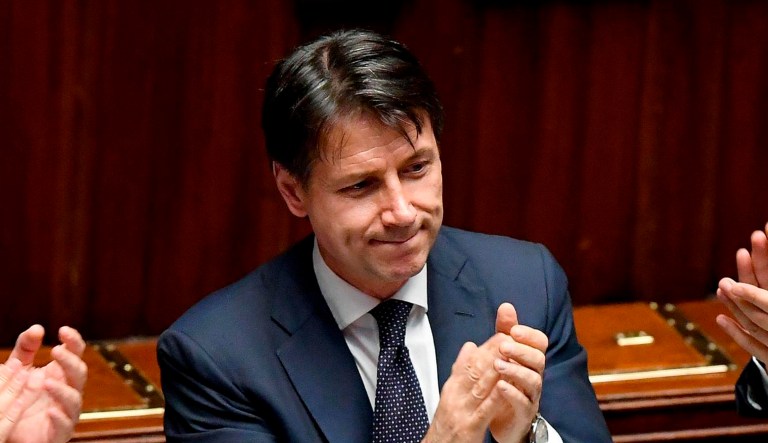 Italian Prime Minister Giuseppe Conte applauds after his government won a confidence vote at the Lower Chamber of Deputies in Rome on Wednedsay.