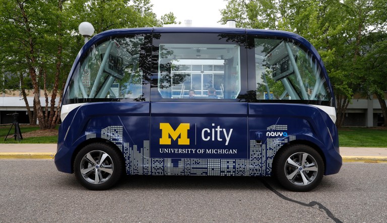 In this June 4, 2018, photo, an Mcity driverless shuttle is shown at the University of Michigan in Ann Arbor, Mich. Dozens of self-driving shuttles made by French autonomous vehicle company Navya are now ferrying passengers at hospitals, airports and public roads worldwide. Last week the University of Michigan began running two of its shuttles on a part of its campus.