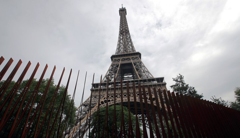 This photo shows a new metal barrier under construction around the Eiffel Tower in Paris, France on Thursday.