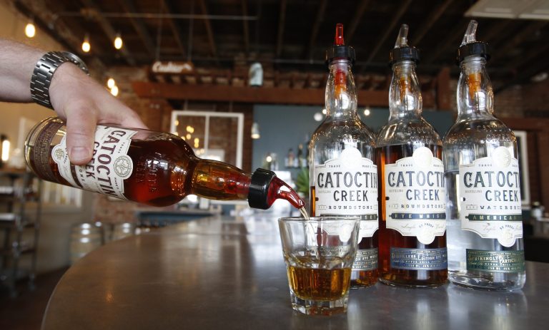 Catoctin Creek Distillery co-founder Scott Harris pours a tasting of whiskey in his tasting room in Purcellville, Va. An escalating trade dispute has Harris worried its European foothold could evaporate as a result of tariffs.