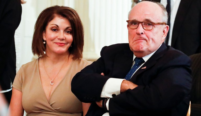 Rudy Giuliani, President Donald Trump's lawyer, right, is seated before President Donald Trump announces Judge Brett Kavanaugh as his nominee for the Supreme Court, in the East Room of the White House, Monday, July 9, 2018, in Washington.