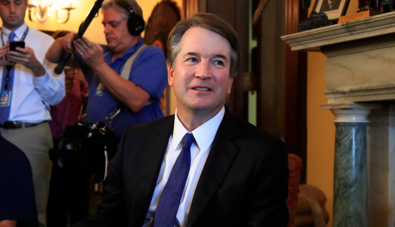 Supreme Court nominee Brett Kavanaugh listens to Sen. Rob Portman, R-Ohio, on Capitol Hill during a meeting on July 11, 2018.