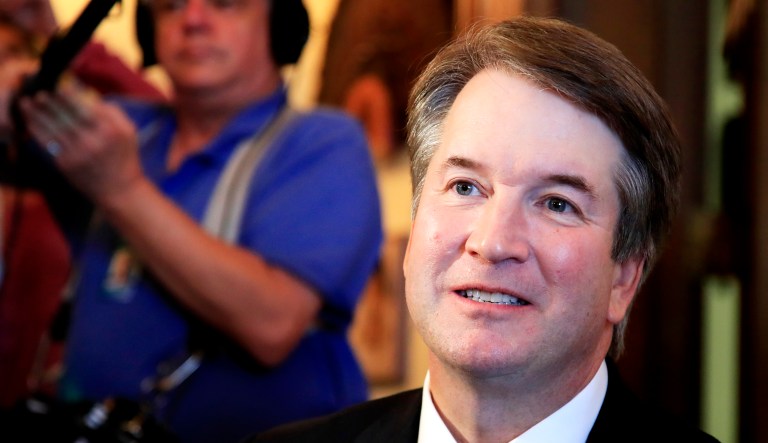 Supreme Court nominee Brett Kavanaugh listens to Sen. Rob Portman, R-Ohio, speak on Capitol Hill in Washington during a Wednesday meeting.