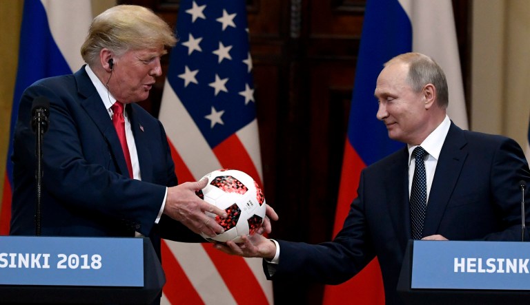 Russian President Vladimir Putin presents a soccer ball to U.S. President Donald Trump during a joint press conference at the Presidential Palace in Helsinki, Finland, Monday, July 16, 2018.