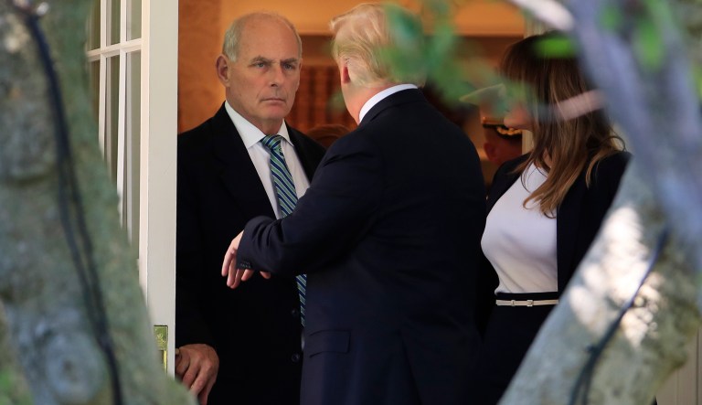 President Donald Trump with first lady Melania Trump, talks to White House Chief of Staff John Kelly as he leaves the Oval Office at the White House in Washington, Wednesday, July 18, 2018.