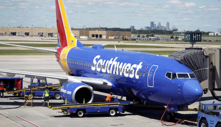 In this Tuesday, July 17, 2018, photograph, ramp workers prepare a Southwest Airlines Boeing 737 for departure to Denver from Minneapolis International Airport in Minneapolis. 