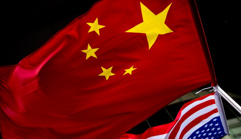 In this Nov. 7, 2012, file photo, U.S. and Chinese national flags are hung outside a hotel during a U.S. presidential election event organized by the U.S. Embassy in Beijing.