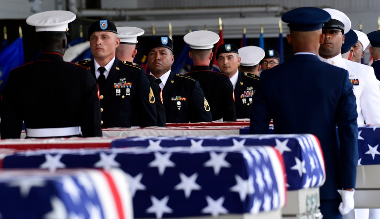 Military members stand at attention at a ceremony marking the arrival of the remains believed to be of American service members who fell in the Korean War at Joint Base Pearl Harbor-Hickam in Hawaii on Aug. 1, 2018.