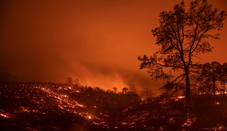 A hillside smolders after flames passed through during the Ranch Fire in Clearlake Oaks, Calif., on Aug. 5, 2018.