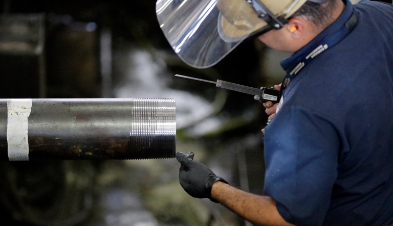 FILE- In this June 5, 2018, file photo, Erik Cordova inspects a steel pipe at the Borusan Mannesmann Pipe manufacturing facility in Baytown, Texas. The U.S. has imposed tariffs of up to 25 percent on thousands of goods including raw metals and finished products from China, Mexico, Canada, India and the European nations, and those countries have retaliated with tariffs of their own on U.S. products ranging from agricultural products to boats. The Institute for Supply Management, said some of its members have said orders from China had fallen, that steel had become more expensive and that companies have had to take on extra inventory, an added cost, in hope of avoiding pricier raw materials. 