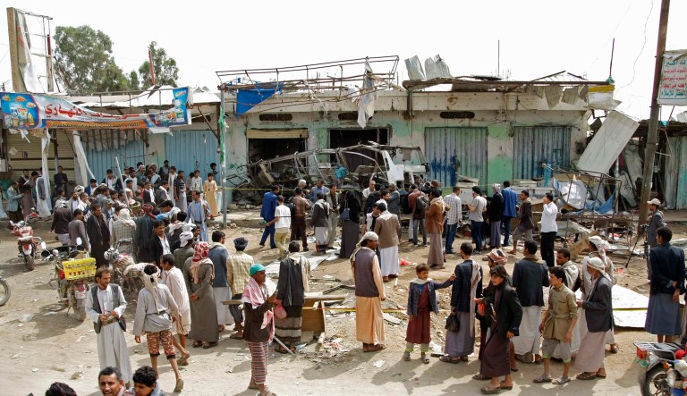 People gather at the site of a deadly Saudi-led coalition airstrike on Thursday, in Saada, Yemen.