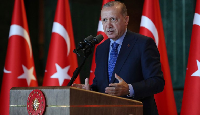 Turkey's President Recep Tayyip Erdogan, gestures as he delivers a speech to Turkish ambassadors at the Presidential Palace in Turkey, Monday, Aug. 13, 2018. Erdogan says his country is under an economic "siege" that has nothing to do with its economic indicators. He insisted that Turkey's economic dynamic remain strong and said the Turkish currency would soon settle "at the most reasonable level."