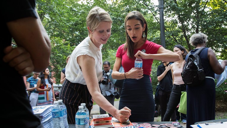 Democratic New York state Senate candidate Julia Salazar and Democratic candidate for governor Cynthia Nixon go over campaign materials before a joint rally in McCarren Park in Brooklyn.
