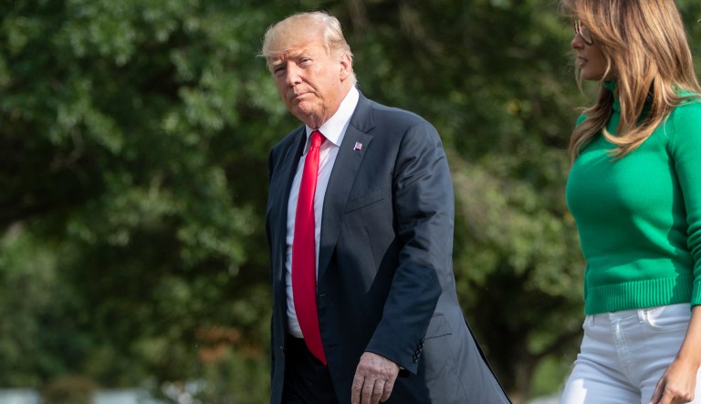 President Donald Trump, with first lady Melania Trump, arrives at the White House in Washington, Sunday, Aug. 19, 2018, after spending the weekend at his golf club in Bedminster, N.J. 