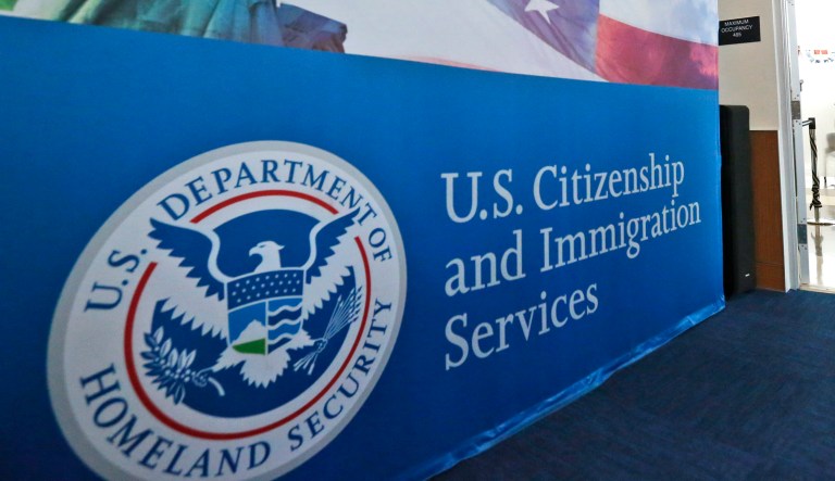 A U.S. Citizenship and Immigration Services sign is seen.