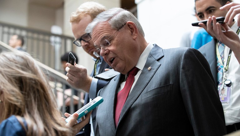 Sen. Bob Menendez, D-N.J., the ranking member of the Senate Foreign Relations Committee, and other members of the Senate head to a closed-door briefing.