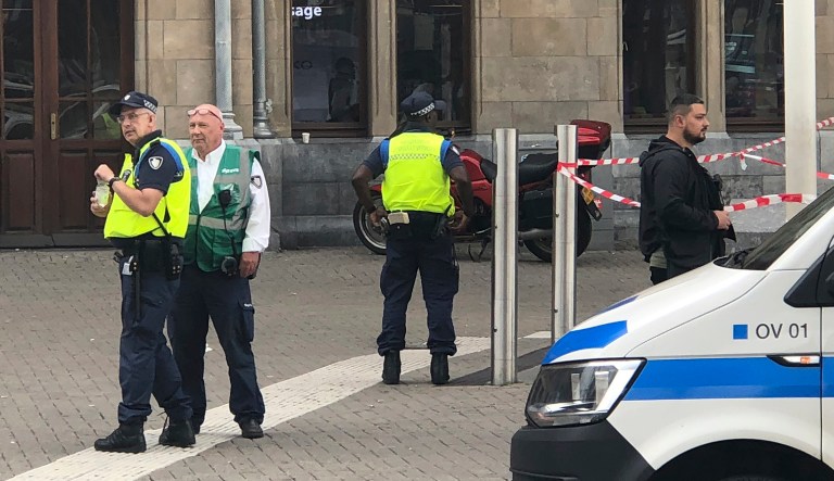 Dutch police officers near the scene of a stabbing attack near the central daily station in Amsterdam, the Netherlands, on Friday.