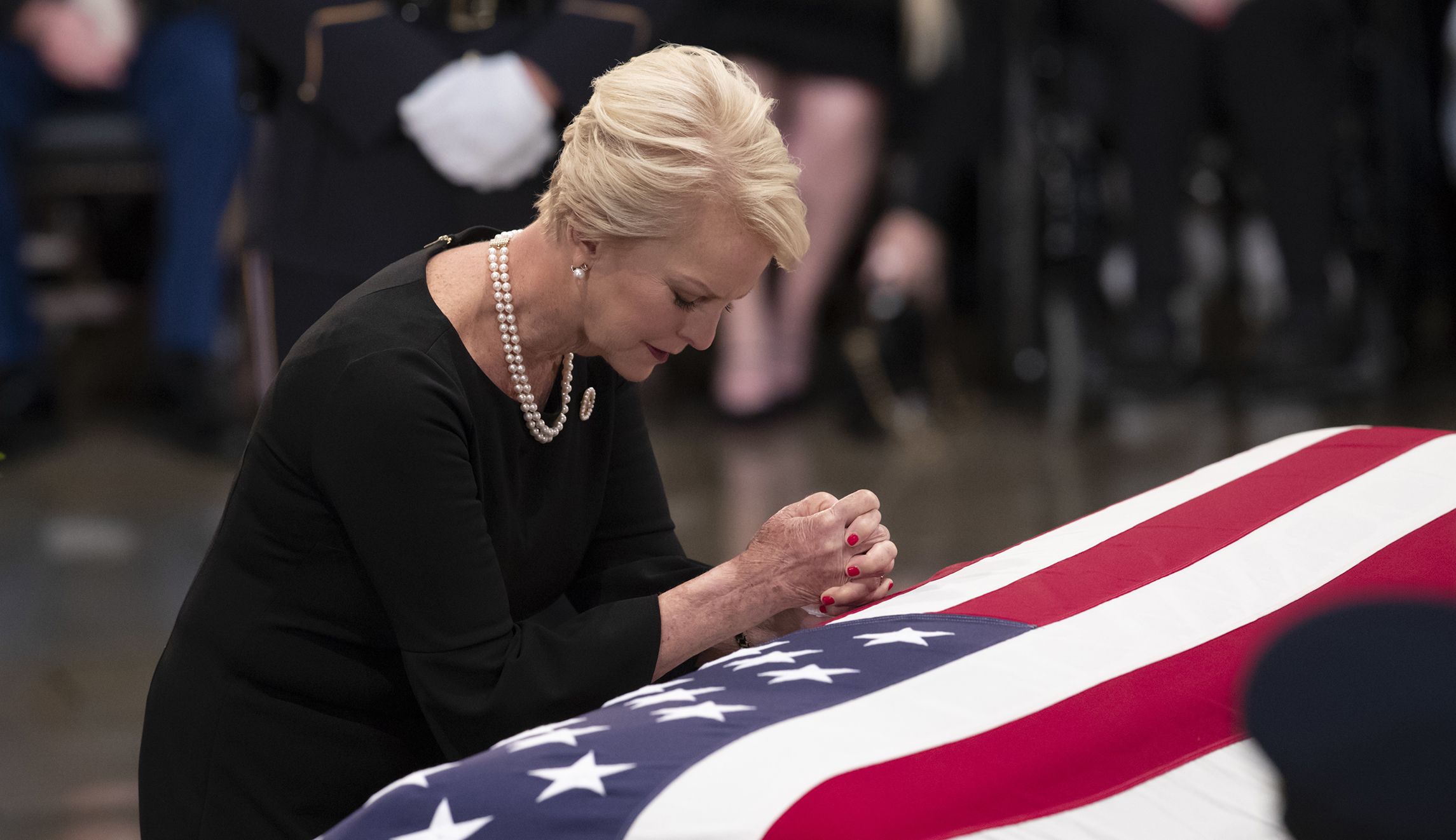 Cindy McCain, wife of Sen. John McCain, R-Ariz., leans on his flag-draped casket during a farewell ceremony in the U.S. Capitol rotunda, Friday, Aug. 31, 2018, in Washington. McCain was a six-term senator, a former Republican nominee for president, and a Navy pilot who served in Vietnam, where he endured five-and-a-half years as a prisoner of war. He died Aug. 25 from brain cancer at age 81.