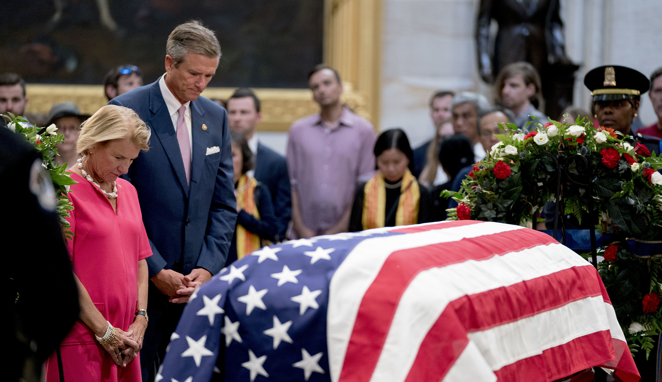 Sen. Shelley Moore Capito, R-W.Va., left, and her husband Charles Capito pay their respects to Sen. John McCain, R-Ariz., as he lies in state in the Rotunda of the U.S. Capitol, Friday, Aug. 31, 2018, in Washington.