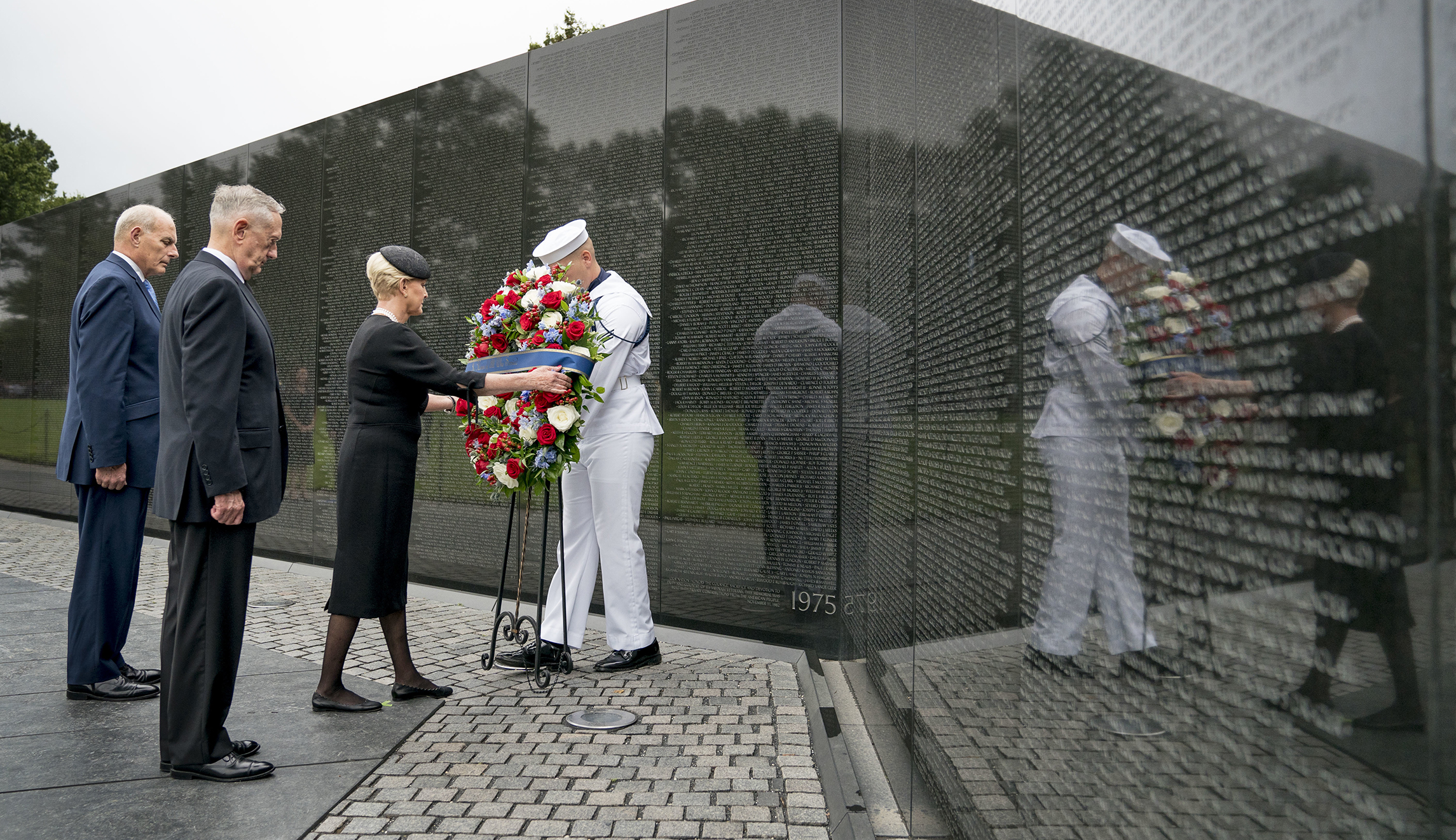 Cindy McCain, wife of, Sen. John McCain, R-Ariz., accompanied by President Trump's Chief of Staff John Kelly, left, and Defense Secretary Jim Mattis, second from left, lays a wreath at the Vietnam Veterans Memorial in Washington, Saturday, Sept. 1, 2018.