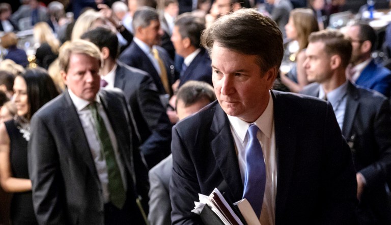 Brett Kavanaugh, President Trump's Supreme Court nominee (pictured center-right), leaves the Senate Judiciary Committee room for a short break on the third day of his confirmation hearing, on Capitol Hill in Washington, D.C.