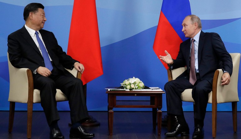 Chinese President Xi Jinping, left, and Russian President Vladimir Putin speak during their meeting at the Eastern Economic Forum in Vladivostok, Russia.