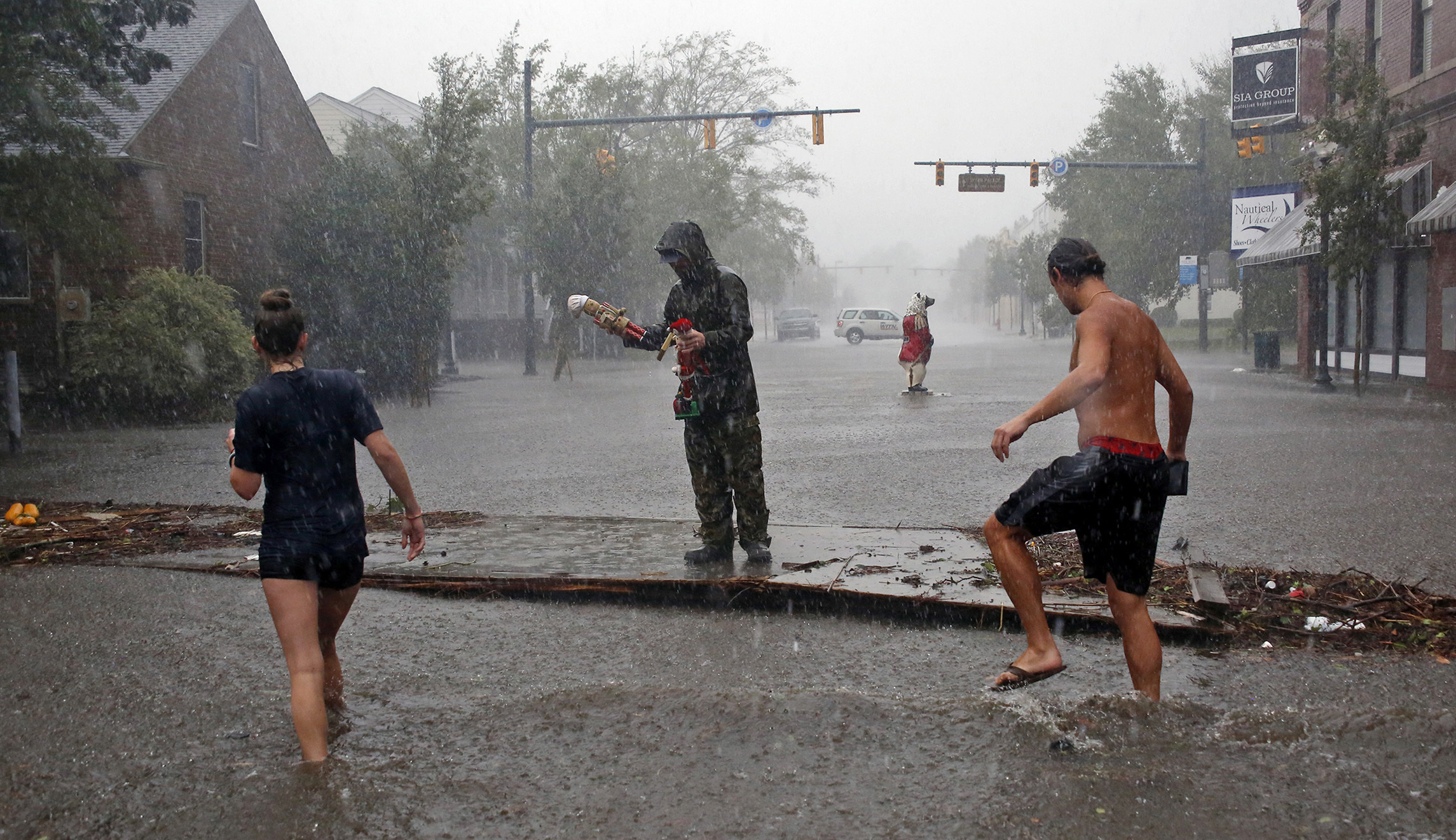 People survey the damage caused by Hurricane Florence on Front Street in downtown New Bern, N.C., on Friday.