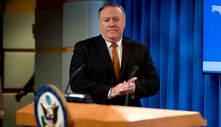 Secretary of State Mike Pompeo arrives to speak at a news conference in the press briefing room at the State Department in Washington, Friday, Sept. 14, 2018, in Washington. Pompeo says his Obama-era predecessor John Kerry has been 'actively undermining' U.S. policy on Iran. 
