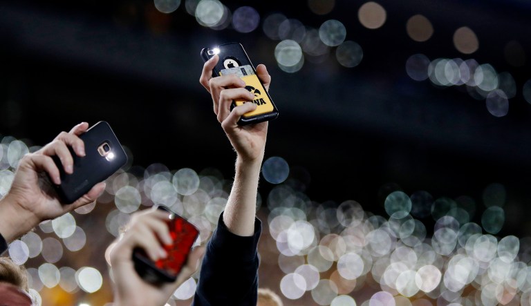 Iowa fans wave to children in the University of Iowa Stead Family Children's Hospital with their cellphones at the end of the first quarter of an NCAA college football game against Wisconsin in Iowa City. 