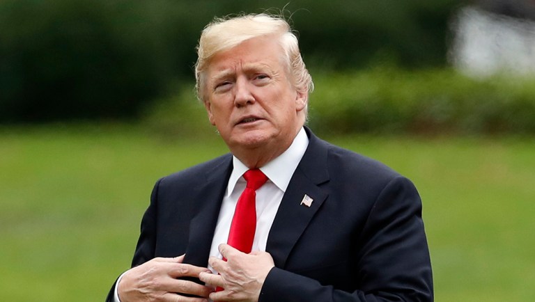 President Trump walks on the South Lawn after stepping off Marine One at the White House.