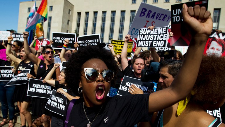 Demonstrators protest against Supreme Court nominee Brett Kavanaugh.