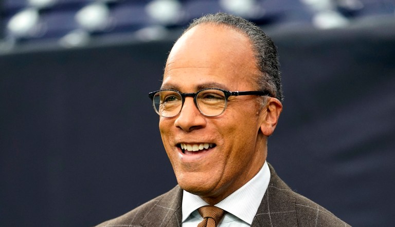 NBC's Lester Holt appears at a football game.