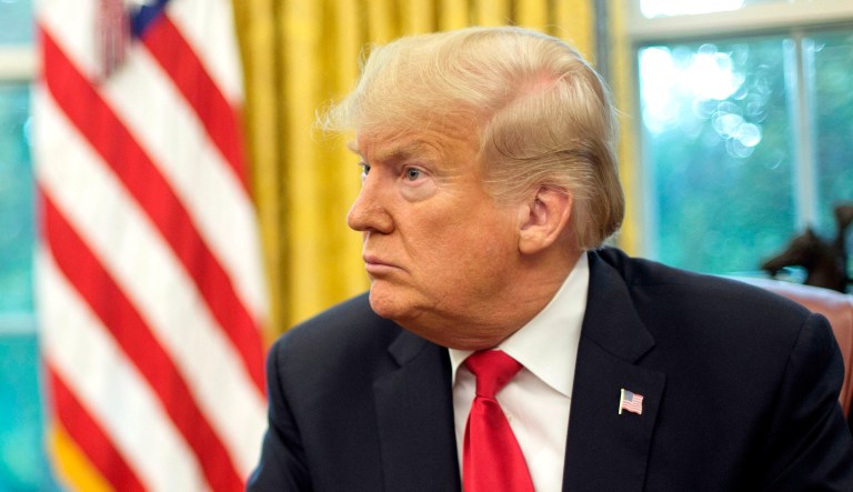 President Trump pauses during a meeting in the Oval Office of the White House in Washington.