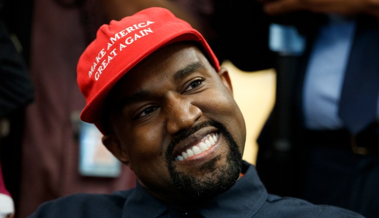 Rapper Kanye West smiles as he listens to a question from a reporter during a meeting in the Oval Office of the White House with President Trump in Washington.