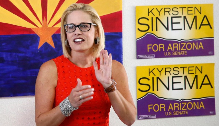 Rep. Kyrsten Sinema, D-Ariz., talks to campaign volunteers at a Democratic campaign office in Phoenix.