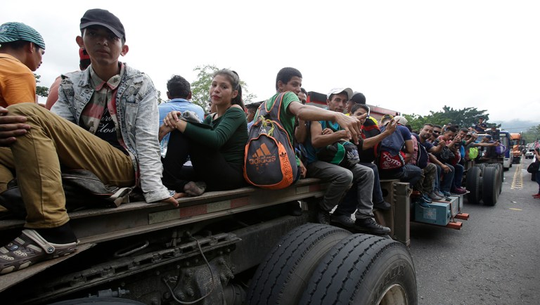 Honduran migrants bound to the U.S border sit on trailers in Zacapa, Guatemala.