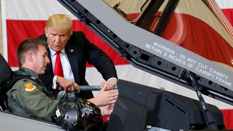 President Trump talks to a pilot in the cockpit of an F-35 aircraft.