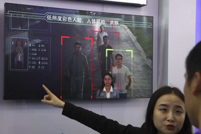 A sales woman introduces human identification technology from state-owned surveillance equipment manufacturer Hikvision.