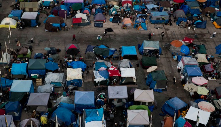 FILE - This Wednesday, Oct. 11, 2017 file photo shows a large homeless encampment at the Santa Ana Civic Center in Santa Ana, Calif. On Wednesday, Oct. 24, 2018, a U.S. advisory committee recommended routine hepatitis A vaccinations for homeless people, following an increase in outbreaks of the contagious liver disease. 
