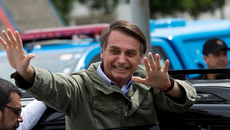 Jair Bolsonaro, presidential candidate with the Social Liberal Party, waves after voting in the presidential runoff election in Rio de Janeiro, Brazil.