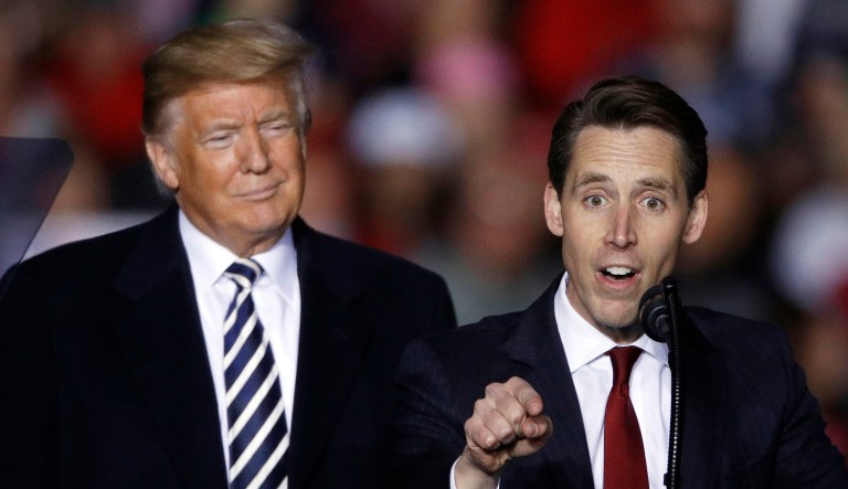 President Trump listens as Republican Senate candidate Josh Hawley speaks during a campaign rally at Columbia Regional Airport on Thursday in Columbia, Mo. 