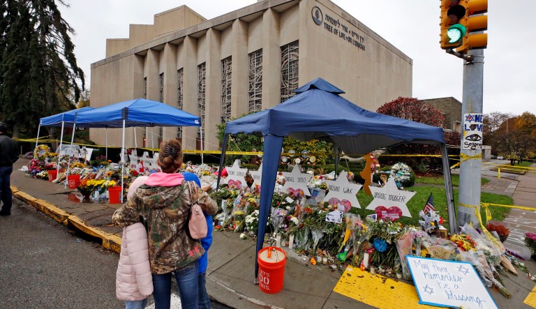 A woman and her children pause Saturday, Nov. 3, 2018, to take in a makeshift memorial outside the Tree of Life Synagogue honoring the 11 people killed Oct 27, 2018 while worshipping in the Squirrel Hill neighborhood of Pittsburgh.