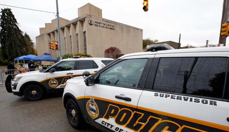 Police vehicles close the street adjacent to the Tree of Life Synagogue on Saturday, Nov. 3, 2018, before a Shabbat morning service is held on the street corner in the Squirrel Hill neighborhood of Pittsburgh.