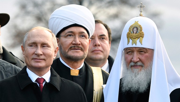 Russian President Vladimir Putin, left, and Russian Orthodox Church Patriarch Kirill, right, pose for a photo with leaders of Russia's main religions.