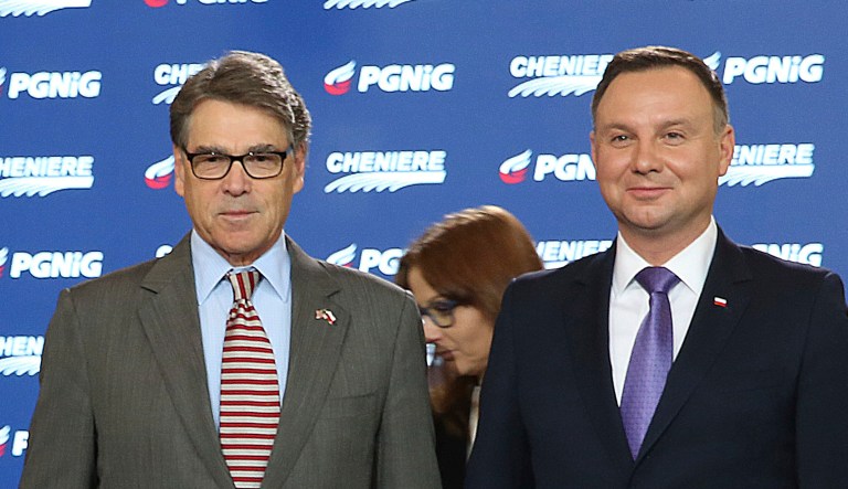 Poland's President Andrzej Duda (right) and U.S. Energy Secretary Rick Perry (left) look on as U.S. gas company Chenier's vice president for trade, Anatol Feygin, and president of Poland's PGNiG gas company, Piotr Wozniak, sign a long-term deal for U.S. liquefied gas deliveries to Poland in Warsaw.