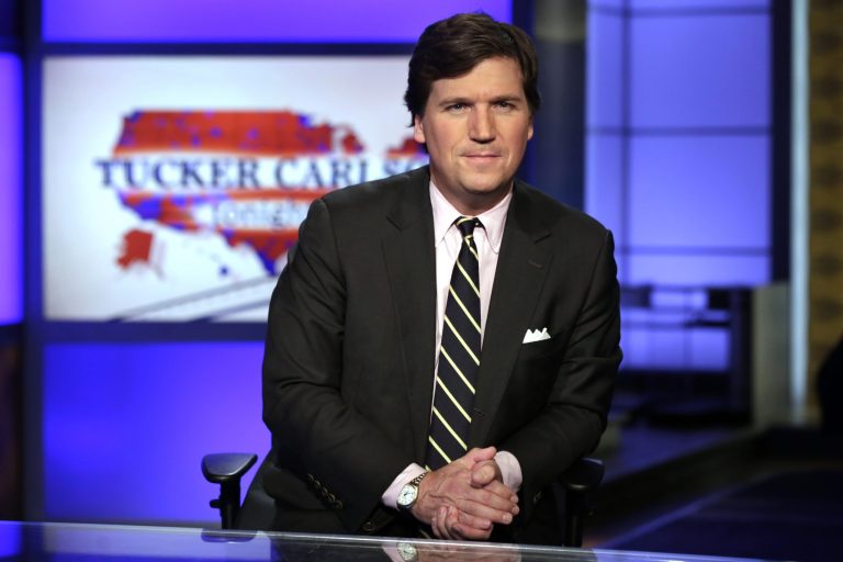 In this March 2, 2017 photo Tucker Carlson, host of "Tucker Carlson Tonight," poses for photos in a Fox News Channel studio in New York. 