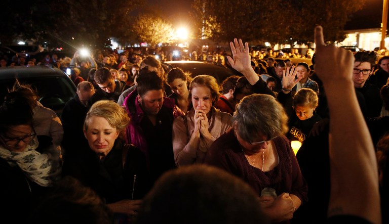 People gather outside a coffee shop for a vigil for Sean Adler Thursday in Simi Valley, Calif. Adler was killed in Wednesday night's mass shooting at the Borderline Bar and Grill in Thousand Oaks, Calif. 