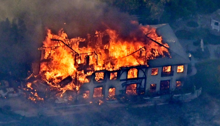 A home burns Friday, Nov. 9, 2018, as seen from a helicopter in the Calabasas section of Los Angeles.