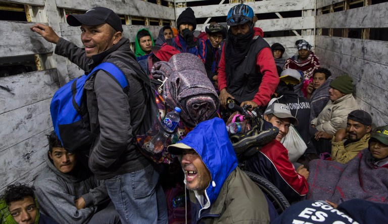 Central American migrants get a ride on a truck going from Mexicali to Tijuana, Mexico, Tuesday, Nov. 20, 2018.